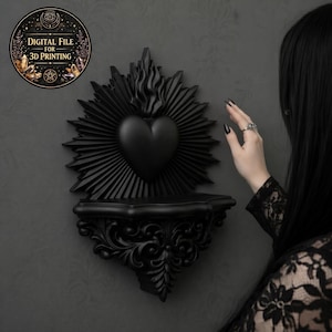 Peut inclure: Étagère murale noire avec un motif en forme de cœur, des rayons de soleil et des détails de flammes. L'étagère présente un design orné et sculpté. Un graphique circulaire indique "FICHIER NUMÉRIQUE POUR L'IMPRESSION 3D".