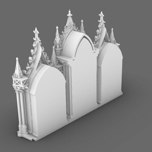 May include: A white, 3D-printed architectural model of a gothic cathedral facade. The model features arched doorways, ornate spires, and detailed decorative elements. The design is symmetrical and stands on a gray surface.
