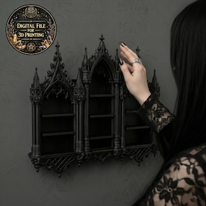 May include: A black gothic-style wall shelf with three compartments. The shelf has an ornate design with pointed arches and decorative elements. A circular sticker with the text "DIGITAL FILE FOR 3D PRINTING" is in the upper left corner.