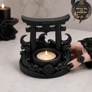 May include: A matte black candle holder shaped like a torii gate with swirling wave patterns and crescent moon accents. The circular base features a central tea light candle with a lit flame. A circular badge in the corner reads DIGITAL FILE FOR 3D PRINTING.