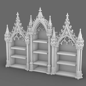 May include: A white, ornate bookshelf with a gothic architectural design. The bookshelf features three sections with shelves, topped with pointed arches and decorative spires. The overall design is symmetrical and detailed.