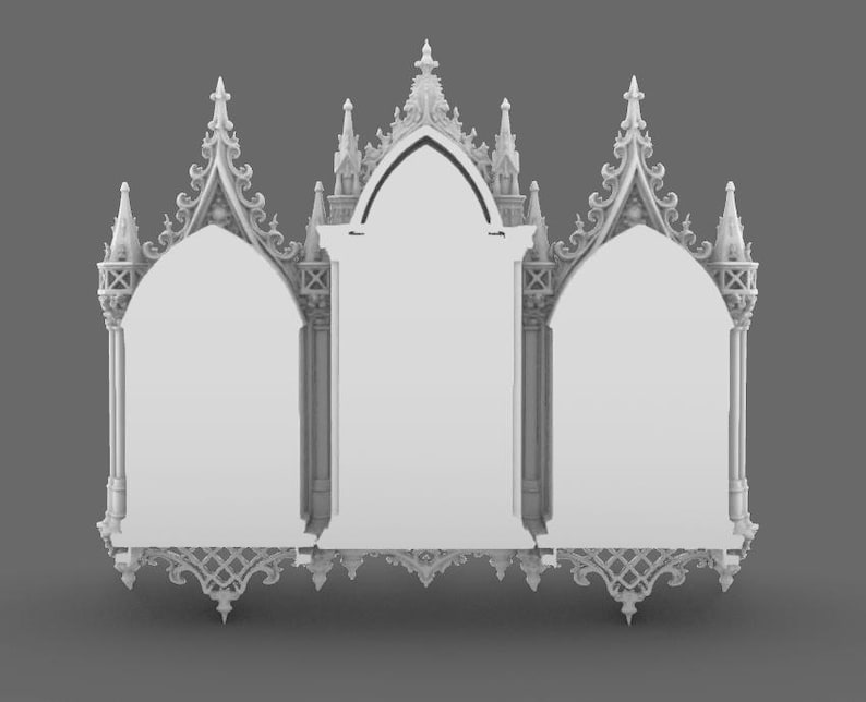 May include: A white, ornate, gothic-style mirror with three arched panels. The mirror features intricate architectural details, including spires, tracery, and decorative carvings. The overall design is symmetrical and elegant, with a focus on vertical lines and pointed arches.