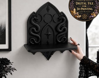 May include: A black wall-mounted shelf featuring a gothic arch design with two sculpted snakes, a central star, and a triple moon symbol. The upper portion has a decorative back panel, and a circular badge reads Digital File for 3D Printing.