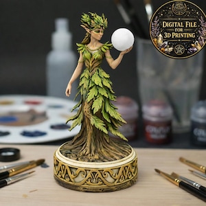 May include: A detailed figurine of a forest nymph holding a white orb. The nymph's dress is made of green leaves, and her base is adorned with gold accents. The image includes text that reads "DIGITAL FILE FOR 3D PRINTING".