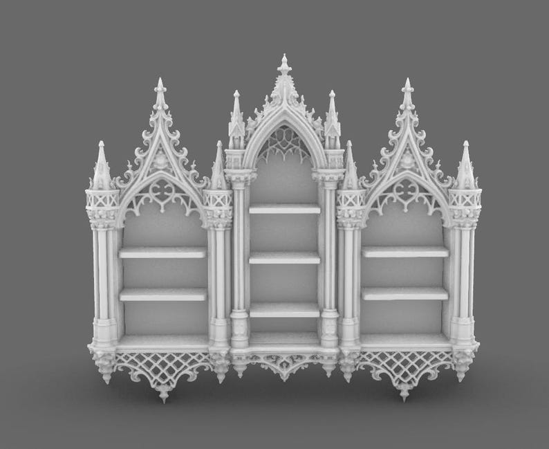 May include: A white, ornate bookshelf with a gothic architectural design. The bookshelf features three sections, each with shelves for storage. The top and bottom of the bookshelf have intricate, decorative patterns, and the overall design is symmetrical.