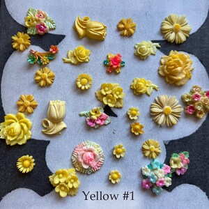 May include: A collection of yellow and pastel-colored flower embellishments in various shapes and sizes. Some flowers are solid yellow, while others have pink, red, and blue accents. The text "Yellow #1" is at the bottom.