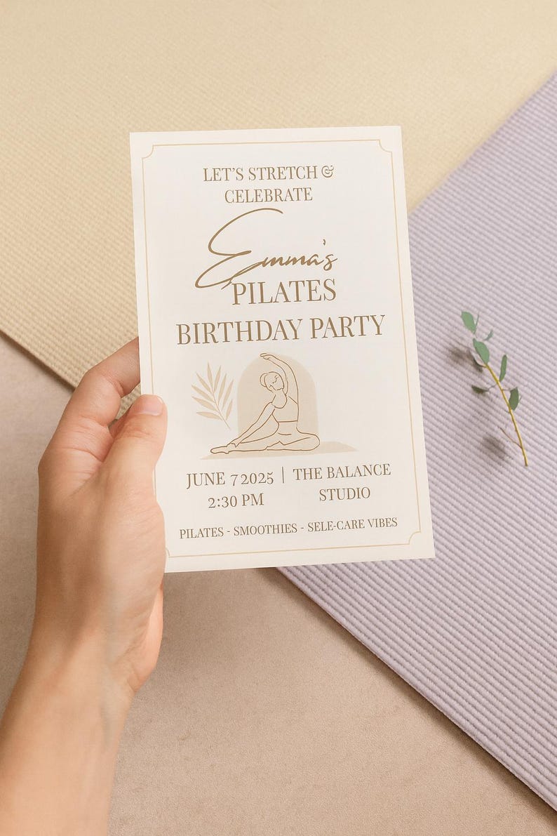 “Printable Pilates Birthday Party invitation held in someone’s hand with pastel yoga mats in the background. Calm, natural lighting and soft tones emphasize the elegant minimalist design. Overlay text reads ‘Editable in Canva – Instant Download’.”