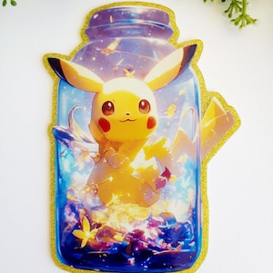 May include: A die-cut sticker featuring a yellow Pikachu character inside a glass jar filled with blue and purple cosmic light, sparkling particles, and small yellow flowers. The sticker has a distinct gold glitter border outline.