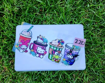 May include: A collection of colorful stickers featuring cartoon characters and beverages. The stickers include a pink My Melody drink, a Hello Kitty mug, a Keroppi coffee, and a Kuromi drink. The number "220" is visible on a small sticker.
