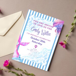 Peut inclure: Une carte d'invitation rectangulaire avec une bordure rayée bleue et blanche, illustrée d'une queue de sirène et d'une méduse à l'aquarelle. Le texte indique : YOU ARE INVITED TO JOIN US FOR Emily Willis 1ST BIRTHDAY CELEBRATION October 30th Saturday.