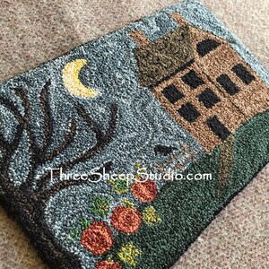 May include: A hand-stitched needlepoint wall hanging featuring a house with a crescent moon, a tree, and pumpkins. The text "Three Sheep Studio.com" is visible in the bottom center of the image.