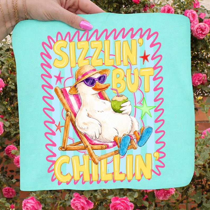 May include: A light blue beach towel with a cartoon duck wearing sunglasses and a straw hat, relaxing in a beach chair and holding a coconut drink. The text "Sizzlin' But Chillin'" is displayed in yellow with a pink border.
