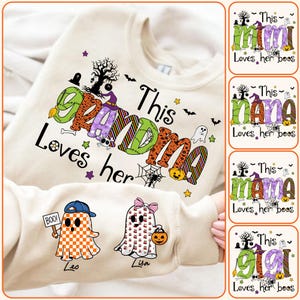 May include: A cream-colored Halloween sweatshirt with the text "This Grandma Loves her boos" in colorful, patterned letters. The design includes ghosts, bats, and a witch. Two ghost characters are also featured.