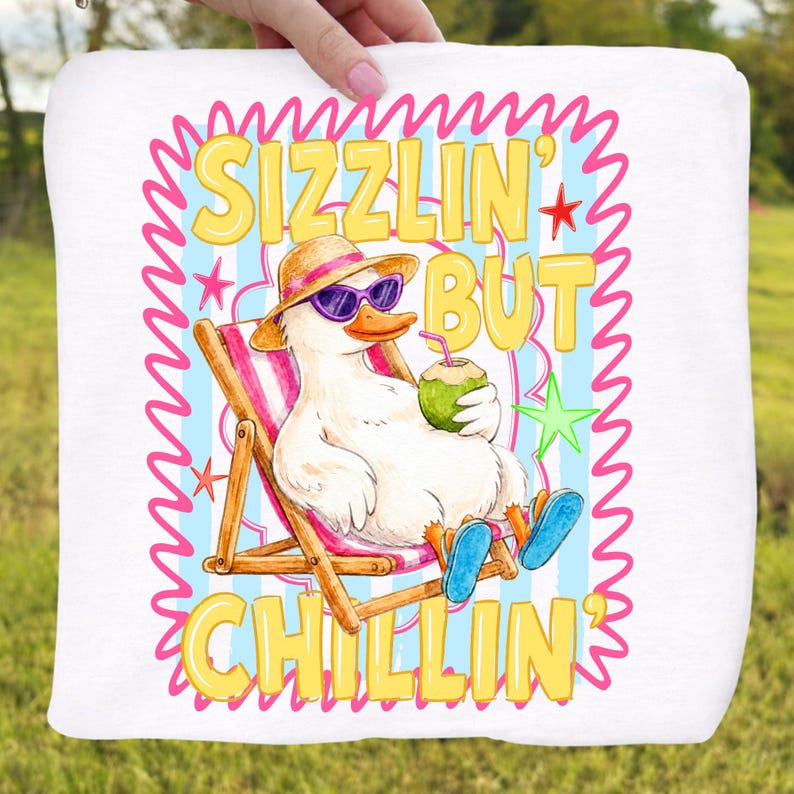May include: White square towel with a cartoon duck wearing sunglasses and a straw hat, relaxing in a beach chair. The text "SIZZLIN' BUT CHILLIN'" is displayed in yellow. The background has blue stripes and pink accents.