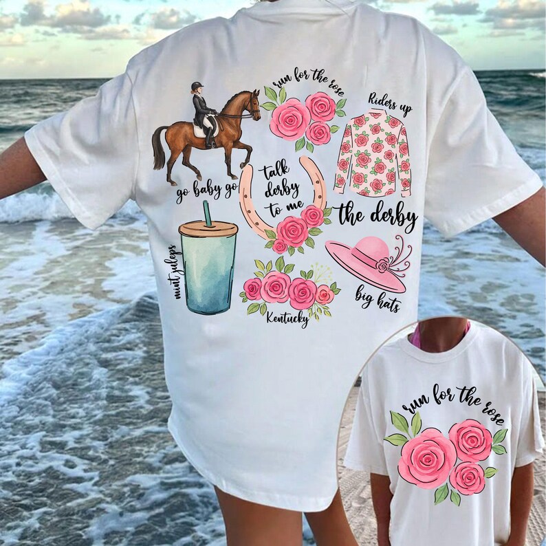 以下が含まれることがあります： ピンクの花柄と「run for the rose」、「go baby go」、「talk derby to me」、「the derby」、「riders up」、「mint juleps」、「Kentucky」、「big hats」という文字が書かれた白いTシャツ。