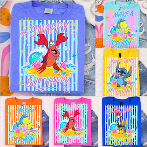 May include: A collection of colorful graphic t-shirts featuring cartoon characters and beach-themed designs. The shirts display phrases like "Snappy But Happy" and "Make a Splash" with vibrant illustrations of sea creatures and tropical elements.