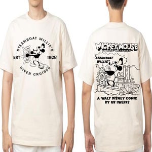 May include: A white t-shirt featuring a black and white illustration of Mickey Mouse on a steamboat. The text "STEAMBOAT WILLIE'S" is printed on the front of the shirt, and the text "MICKEY MOUSE SOUND CARTOON" is printed on the back of the shirt.