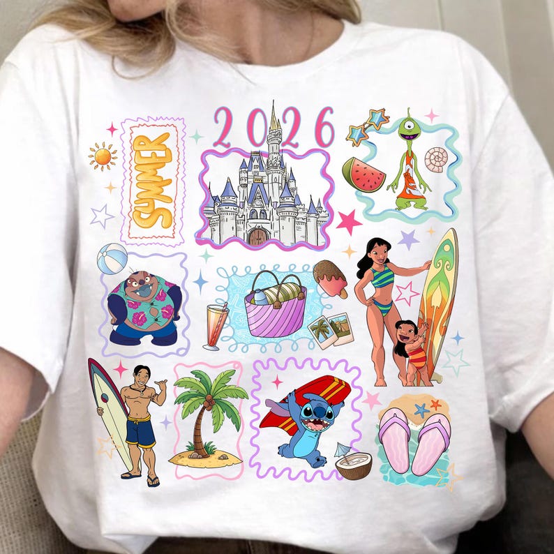May include: White t-shirt with a colorful summer-themed graphic. The design includes illustrations of a castle, characters, a surfboard, and the text "Summer 2026". The overall theme is a vacation or beach setting.