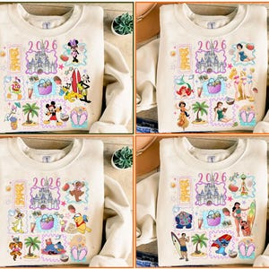 May include: Beige sweatshirt with colorful Disney-themed graphics. The design includes the text "2026" and various characters, a castle, and summer-themed icons. The sweatshirt has long sleeves and a crew neck.