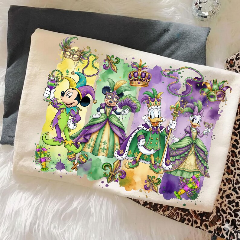 May include: A cream-colored throw pillow featuring a colorful illustration of Disney characters dressed in Mardi Gras attire. Mickey Mouse, Minnie Mouse, Donald Duck, and Daisy Duck are depicted in festive costumes with masks, crowns, and beads. The design includes purple, green, and gold accents.