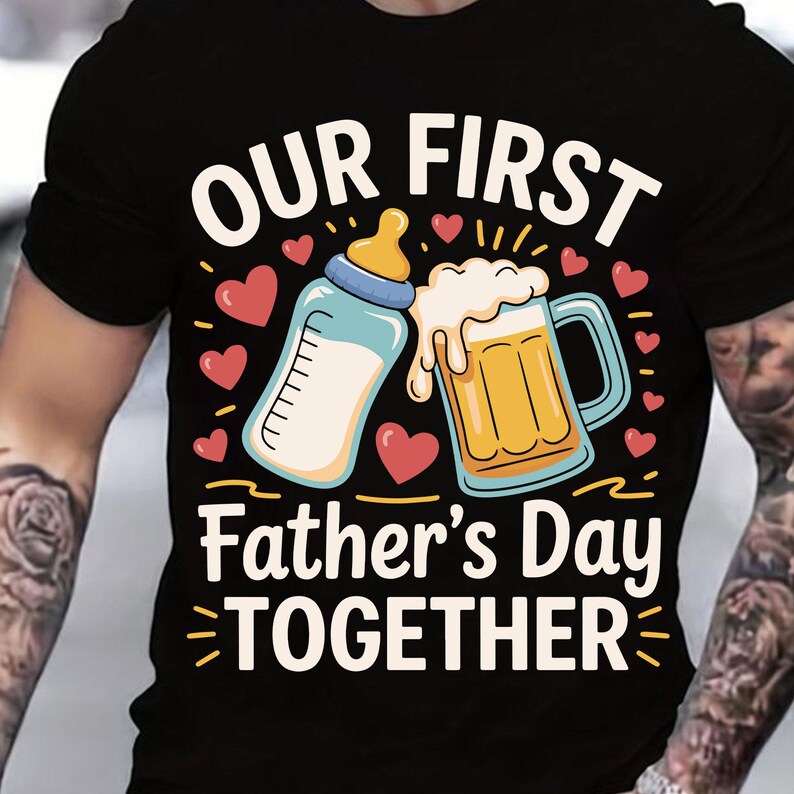May include: Black t-shirt with a graphic of a baby bottle and a beer mug clinking together. The text "Our First Father's Day Together" is printed below the graphic.