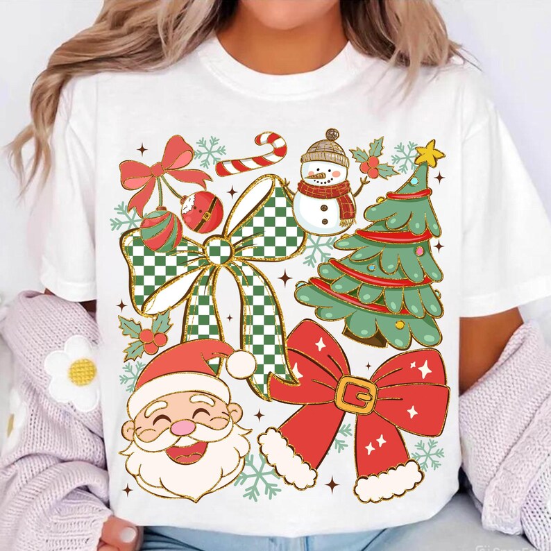 May include: White t-shirt featuring a festive Christmas design. The graphic includes a snowman, Santa Claus, a Christmas tree, bows, ornaments, and snowflakes. The design incorporates red, green, gold, and white colors, creating a cheerful holiday theme.