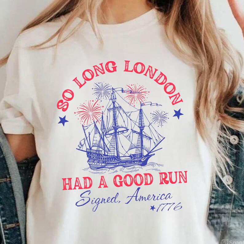 May include: White t-shirt with a blue and red graphic of a tall ship, fireworks, and text that reads "So Long London, Had a Good Run, Signed, America, *1776". The design is patriotic and vintage-inspired.