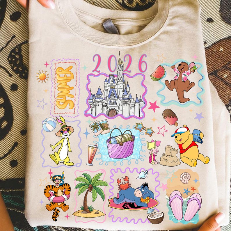 May include: Beige t-shirt with colorful cartoon illustrations of Disney characters and summer-themed elements. The design includes a castle, the word "Summer", the year "2026", and various characters like Winnie the Pooh and Tigger.