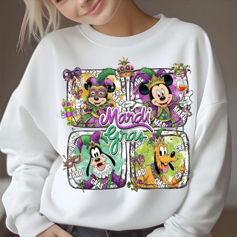 May include: White sweatshirt featuring a colorful Mardi Gras design. The graphic includes Mickey Mouse, Minnie Mouse, Goofy, and Pluto in festive attire, with the words "Mardi Gras" in a vibrant font. The design incorporates purple, green, and gold.
