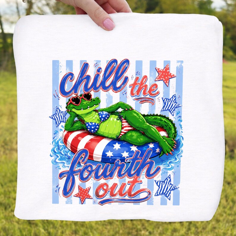 May include: White towel featuring a cartoon alligator wearing sunglasses and a bikini, lounging on a red, white, and blue inner tube. The text "Chill the Fourth Out" is written in blue and red script.