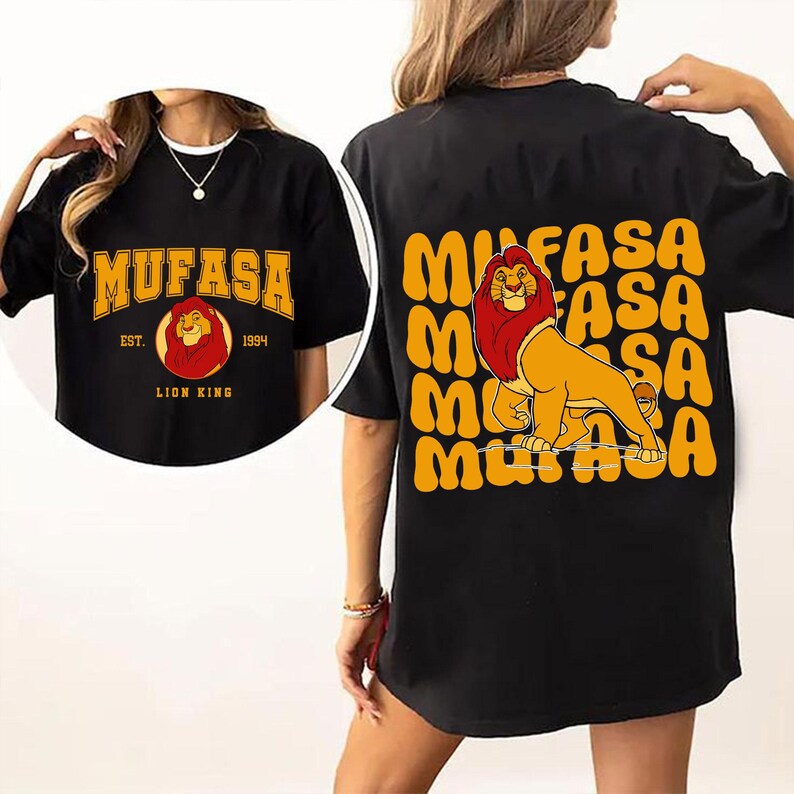 May include: Black t-shirt with a graphic print of a lion with the text "MUFASA EST. 1994 LION KING" on the front and the text "MUFASA" repeated in a stacked pattern on the back.