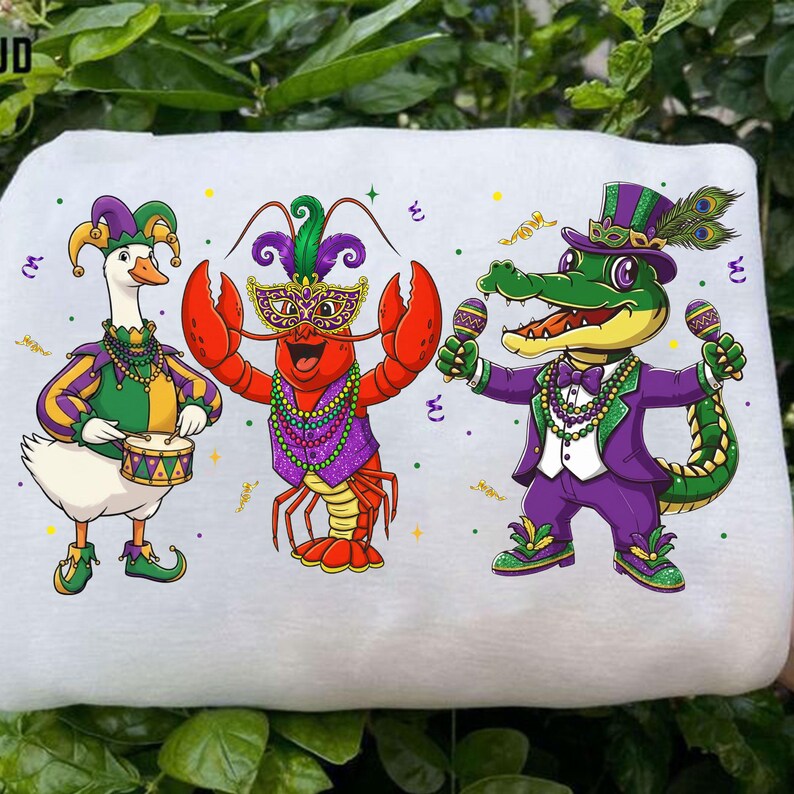 May include: White fabric featuring three cartoon characters in festive attire. A goose plays a drum, a lobster wears a mask, and an alligator holds maracas. All are dressed in purple, green, and gold, with confetti scattered around.