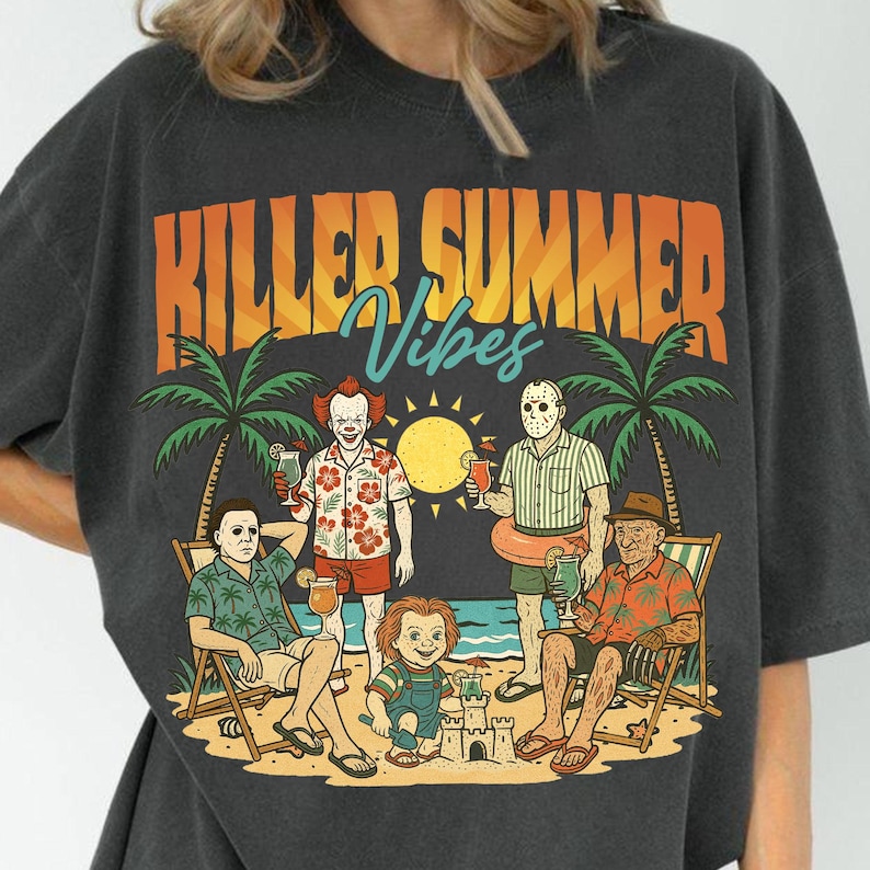 May include: Dark gray t-shirt with a graphic featuring horror movie characters on a beach with the text "Killer Summer Vibes." The design includes palm trees, a sun, and characters like Pennywise and Jason Voorhees.