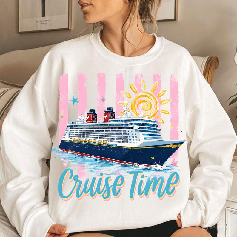 May include: White sweatshirt featuring a cruise ship illustration, pink stripes, and a yellow sun. The text "Cruise Time" is in blue and yellow. The sweatshirt is a casual style, suitable for leisure wear.