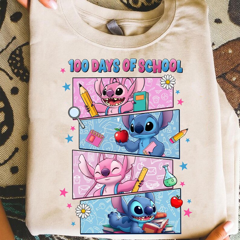 May include: Beige t-shirt with the text "100 Days of School" and a colourful graphic. The graphic features cartoon characters, pencils, books, and other school-related elements. The design is set against a light blue and pink background.