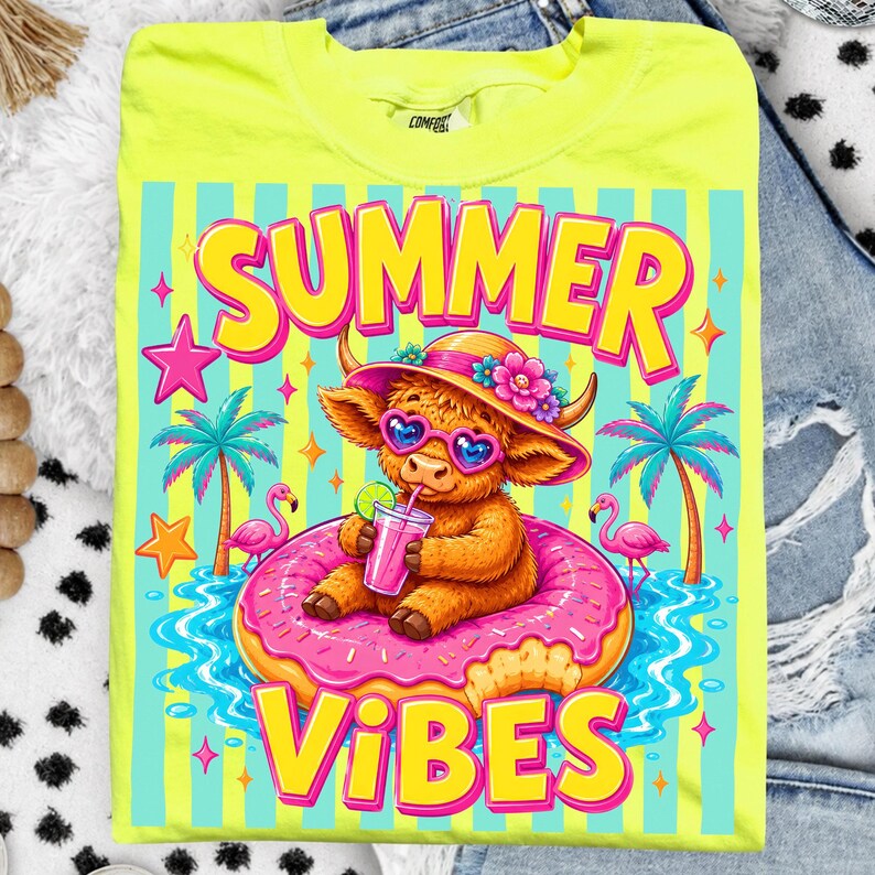 May include: Neon yellow t-shirt with a colorful graphic. The graphic features a cartoon Highland cow wearing heart-shaped sunglasses and a floral hat, floating on a pink donut in water. The words "SUMMER VIBES" are in large, bright letters.