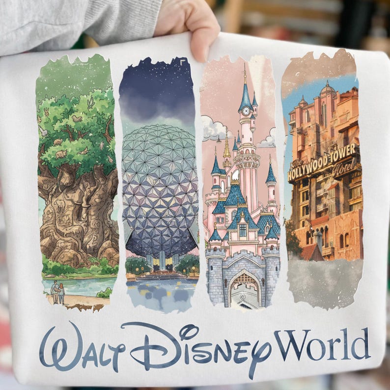 May include: White sweatshirt featuring watercolor illustrations of Disney World landmarks: the Tree of Life, Spaceship Earth, Cinderella Castle, and the Hollywood Tower Hotel. The words "Walt Disney World" are printed in blue script below the images.
