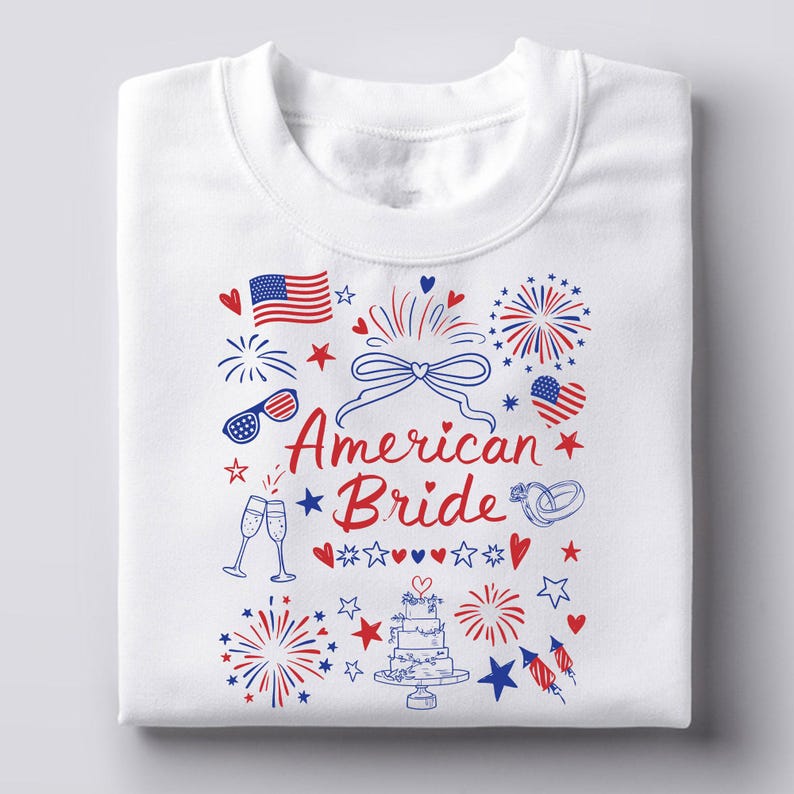 May include: White sweatshirt with a patriotic design featuring an American flag, fireworks, hearts, stars, and the words "American Bride" in red and blue. Includes champagne glasses, sunglasses, and a wedding cake.