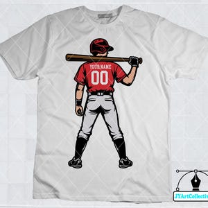 May include: White t-shirt with a baseball player graphic. The player is wearing a red jersey with the text "Your Name" and the number "00".