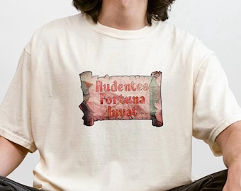 May include: A white t-shirt with a red and white graphic of a scroll with the text "Audentes Fortuna Iuvat" on it.