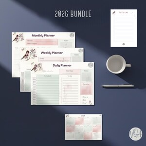 May include: A 2026 bundle of planners and a calendar. The bundle includes a monthly, weekly, and daily planner, along with a to-do list. The planners feature a bird and floral design with pink and green accents. A white mug and pen are also included.