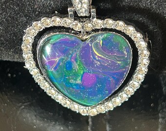Handmade custom one of a kind necklace. Each piece is custom made and designed. This necklace the heart spins showing two different sides.