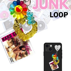 May include: A keychain with a colorful flower, a blue gummy bear, and a gold heart-shaped charm. The keychain is attached to a CD album cover. The words "JUNK LOOP" are in pink and black text.
