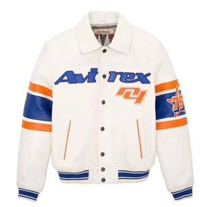May include: Cream-colored leather jacket with blue and orange accents. Features the brand name "Avi-rex" in blue lettering across the chest, along with the number "75" and a star graphic on the sleeve. The jacket has a button-up front and striped details.