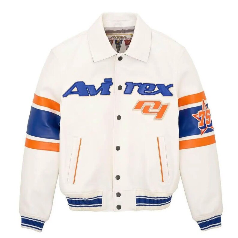 May include: Cream-colored leather jacket with blue and orange accents. Features the brand name "Avi-rex" in blue lettering across the chest, along with the number "75" and a star graphic on the sleeve. The jacket has a button-up front and striped details.