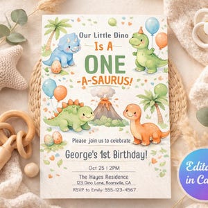 May include: A watercolor dinosaur-themed birthday invitation with the text "Our Little Dino Is A ONE -A-SAURUS!" and "George's 1st Birthday!" The invitation features illustrations of dinosaurs, balloons, and palm trees. The invitation is surrounded by baby toys.