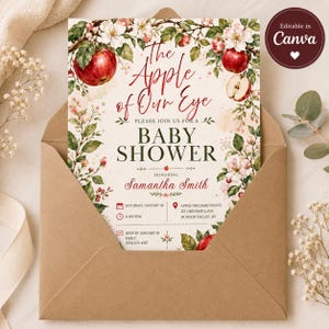 Puede incluir: Una tarjeta de invitaci&oacute;n rectangular para baby shower con ilustraciones en acuarela de manzanas rojas, hojas verdes y flores blancas. El texto dice The Apple of Our Eye, Baby Shower, en honor a Samantha Smith, con un sobre marr&oacute;n.