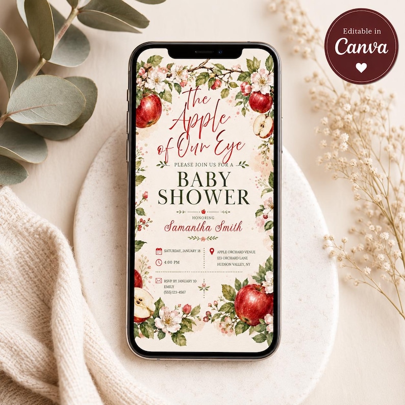 Puede incluir: Una invitaci&oacute;n digital para baby shower en la pantalla de un tel&eacute;fono inteligente con manzanas rojas, flores de manzano blancas y hojas verdes. El texto dice: The Apple of Our Eye, Baby Shower, en honor a Samantha Smith, 18 de enero, 4:00 PM.