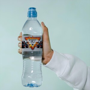 May include: A clear plastic water bottle with a blue cap and a label that says "YOUR NAME DRINK" with a monster truck graphic.