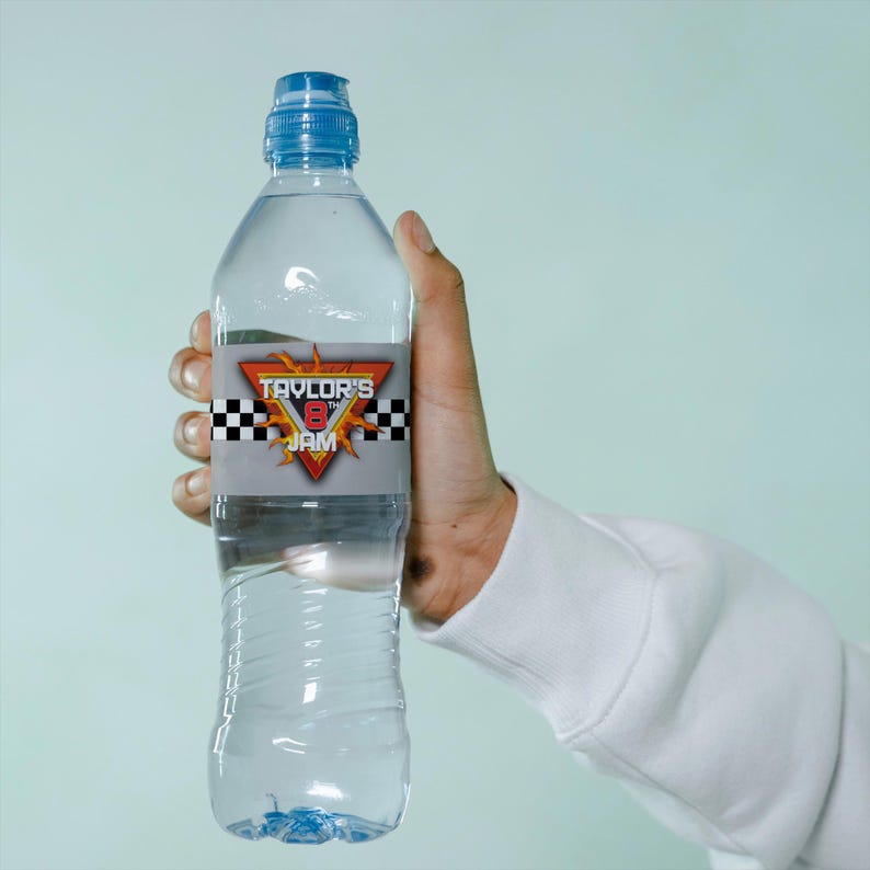 May include: A clear plastic water bottle with a blue cap and a label that says "Taylor's 8th Jam" with a checkered flag and flames design.